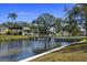 Peaceful waterfront view with homes and lush landscaping at 204 Sky Loch W Dr, Dunedin, FL 34698