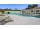 Relaxing community pool area with surrounding lounge chairs at 204 Sky Loch W Dr, Dunedin, FL 34698