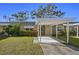 Cute Florida home with carport and well-manicured lawn at 204 Sky Loch W Dr, Dunedin, FL 34698