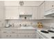 White kitchen with updated countertops and cabinets at 204 Sky Loch W Dr, Dunedin, FL 34698