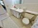 Updated bathroom with toilet, sink, and tiled flooring at 2222 Americus N Blvd # 2, Clearwater, FL 33763