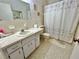 Clean bathroom with shower/tub combo, vanity, and tile floor at 2222 Americus N Blvd # 2, Clearwater, FL 33763