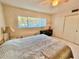 Bedroom with a queen bed and sliding doors to closet at 2222 Americus N Blvd # 2, Clearwater, FL 33763