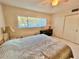 Bedroom with a queen bed and sliding doors to closet at 2222 Americus N Blvd # 2, Clearwater, FL 33763