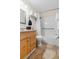 Clean bathroom with wood cabinets and a tub shower combo at 2506 N Rocky Point Dr # 272, Tampa, FL 33607