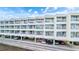 Waterfront condo building with parking underneath and balconies at 2506 N Rocky Point Dr # 272, Tampa, FL 33607