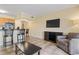 Living room with kitchen, tile floors, and TV at 2506 N Rocky Point Dr # 272, Tampa, FL 33607