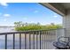 Stunning waterfront view from private balcony, showcasing palm trees and resort at 2506 N Rocky Point Dr # 272, Tampa, FL 33607