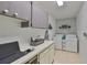 Laundry room with washer, dryer, cabinets, and workspace at 2510 Lambdin Dr, Sun City Center, FL 33573