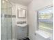 Clean bathroom with a shower, vanity, and window at 281 Grove Rd, Venice, FL 34293