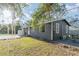 Dark gray house exterior with a grassy yard and patio area at 281 Grove Rd, Venice, FL 34293