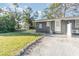 Side view of a gray duplex building with a small yard at 281 Grove Rd, Venice, FL 34293