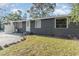 Gray house exterior with landscaping and a private yard at 281 Grove Rd, Venice, FL 34293