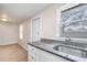 Modern kitchen with granite countertops and white cabinets at 281 Grove Rd, Venice, FL 34293