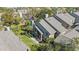 Aerial view of condo building showcasing rooflines and landscaping at 3079 Landmark Blvd # 1606, Palm Harbor, FL 34684