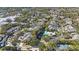 Aerial view of a large community with houses, trees, and a pool at 3079 Landmark Blvd # 1606, Palm Harbor, FL 34684