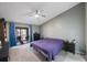 Spacious bedroom with purple bedding and access to a balcony at 3079 Landmark Blvd # 1606, Palm Harbor, FL 34684