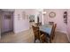 Dining area features a wooden table and light walls at 3079 Landmark Blvd # 1606, Palm Harbor, FL 34684