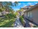 Side view of condo showing walkway and landscaping at 3079 Landmark Blvd # 1606, Palm Harbor, FL 34684