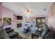 Living room with gray sofas, fireplace, and wood floors at 3079 Landmark Blvd # 1606, Palm Harbor, FL 34684