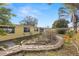 Exterior side view of home with yellow exterior, and established trees in the yard at 3235 Merita Dr, Holiday, FL 34691