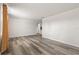 Bright living room featuring new wood floors, fresh white paint and a large window for natural light at 3235 Merita Dr, Holiday, FL 34691