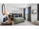 Cozy bedroom with a green duvet, wood accents, and ample natural light at 32465 Osprey Peak Way, San Antonio, FL 33576