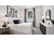 Serene bedroom featuring a white bed, dark accents, and natural light at 32465 Osprey Peak Way, San Antonio, FL 33576