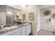 Elegant bathroom with double sinks, granite countertop, and walk-in shower at 32474 Osprey Peak Way, San Antonio, FL 33576