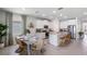 Kitchen and dining area with farmhouse table and wicker chairs at 32474 Osprey Peak Way, San Antonio, FL 33576