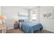 Cozy bedroom with blue bedding and ample natural light at 33217 Osprey Peak Way, San Antonio, FL 33576