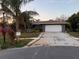 Single-story home with gray exterior, white garage door, and landscaping at 3544 Snowy Egret Ct, Palm Harbor, FL 34683