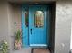 Bright teal front door with arched glass and sidelight at 3544 Snowy Egret Ct, Palm Harbor, FL 34683