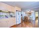 Kitchen with peach cabinets, white appliances, and dining area at 37350 Tropical Dr, Zephyrhills, FL 33541