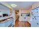 Bright kitchen features white appliances and light peach cabinets at 37350 Tropical Dr, Zephyrhills, FL 33541