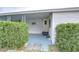 Side entrance to the mobile home with covered patio and landscaping at 37350 Tropical Dr, Zephyrhills, FL 33541