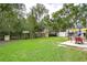 Backyard with patio, shade sail, and grassy area at 38902 Inez Ave, Zephyrhills, FL 33542