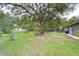 Spacious backyard with grassy area and fire pit at 38902 Inez Ave, Zephyrhills, FL 33542