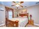 Charming bedroom with wood bed frame and ceiling fan at 38902 Inez Ave, Zephyrhills, FL 33542