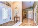 Bright entryway with hardwood floors and a glass front door at 38902 Inez Ave, Zephyrhills, FL 33542