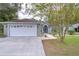 White garage door, landscaped yard, and a charming house exterior at 38902 Inez Ave, Zephyrhills, FL 33542