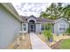 Front entry with walkway, fountain, and screen door at 38902 Inez Ave, Zephyrhills, FL 33542