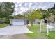 House exterior with driveway and white garage door at 38902 Inez Ave, Zephyrhills, FL 33542