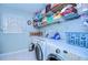 Bright laundry room, washer, dryer, and ample storage shelves at 38902 Inez Ave, Zephyrhills, FL 33542