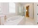 Relaxing bathroom with a large soaking tub and marble finishes at 3898 Barbour Trail, Odessa, FL 33556