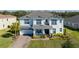 Two-story home with gray roof, white siding, and landscaping at 3898 Barbour Trail, Odessa, FL 33556