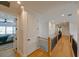 Light-filled hallway with hardwood floors and access to bedrooms at 3898 Barbour Trail, Odessa, FL 33556