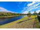 Peaceful waterfront view with a tranquil pond and lush greenery at 3898 Barbour Trail, Odessa, FL 33556