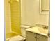 Bathroom featuring a tub with yellow tiling, toilet, sink, and vanity at 4208 Winding Moss Trl # 102, Tampa, FL 33613