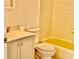 Bathroom featuring a tub with yellow tile, toilet, sink, and vanity with neutral walls at 4208 Winding Moss Trl # 102, Tampa, FL 33613